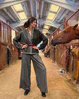 Model wearing KIMONO CORTO PATCHWORK NEW JAPANDI in stable with horse, showcasing unique patchwork design.